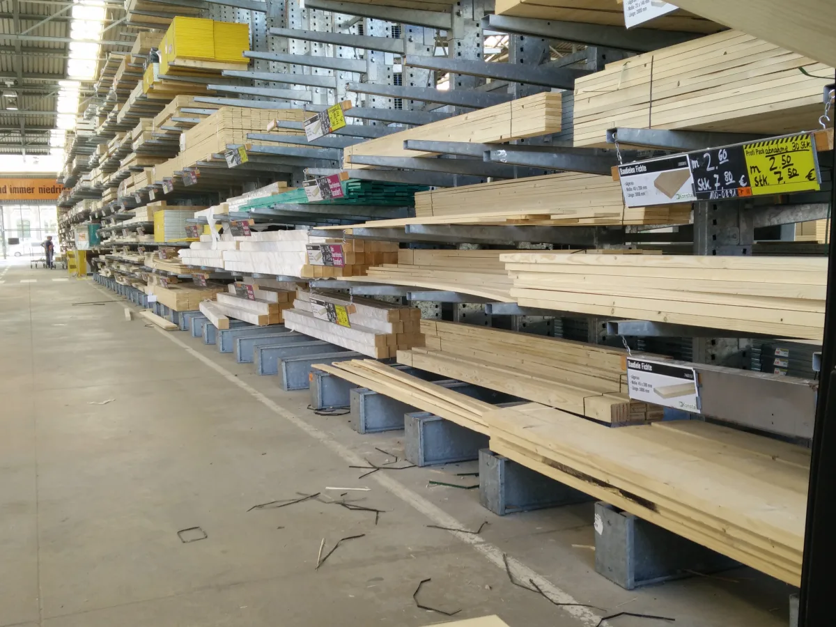 Organized stacks of building materials in a supply warehouse.