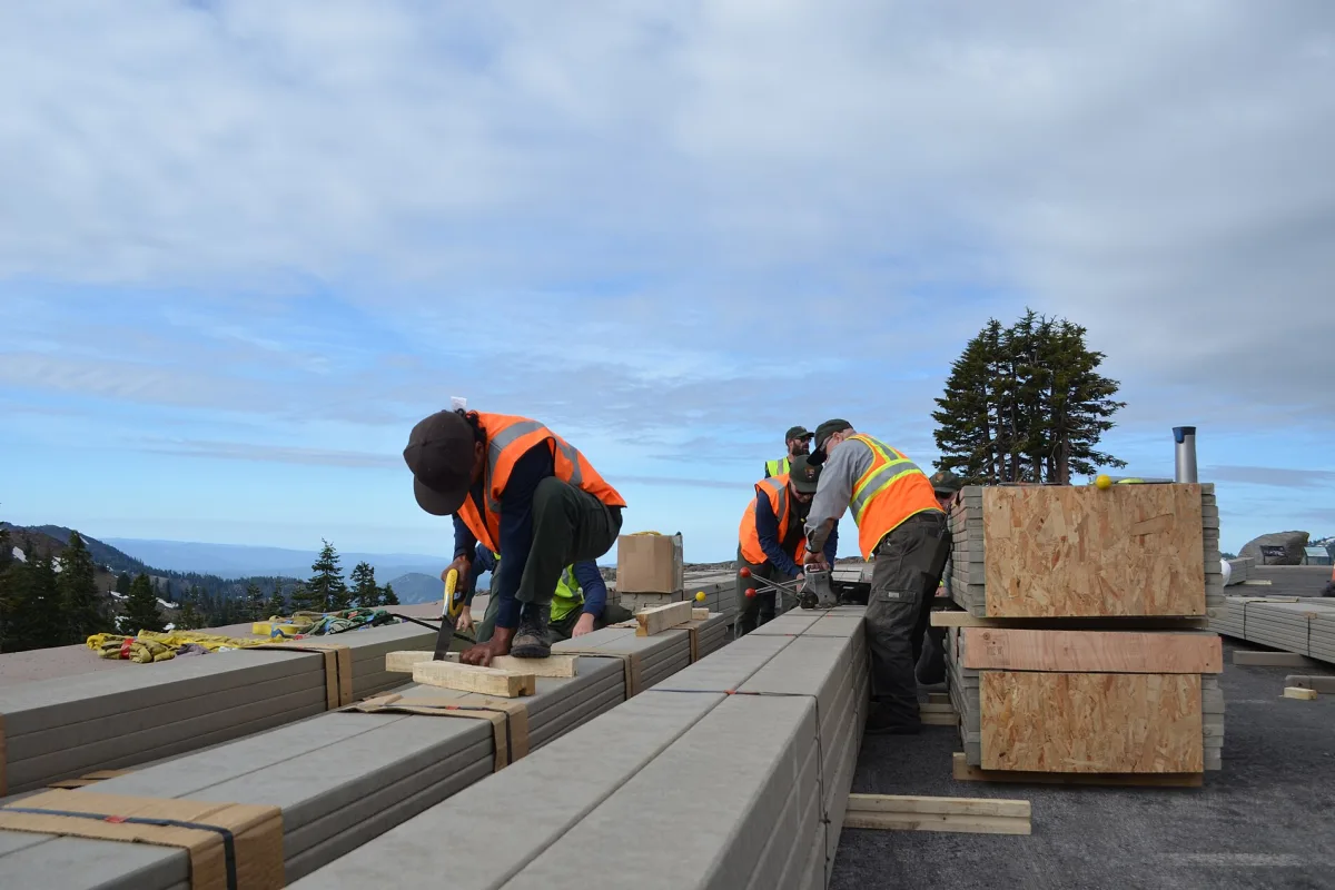 Neatly stacked and sorted dimensional lumber on warehouse racks.